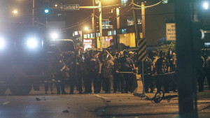 Police officers face down protestors in Ferguson on Saturday night. Photo/Lawrence Bryant / St. Louis American