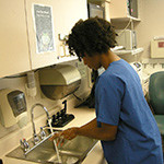 Medical worker illustrates frequent handwashing as one way to prevent the spread of Ebola. Photo/CDC.gov.