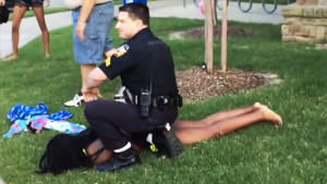 A White police officer restrains Dajerria Becton at a pool party in McKinney, Texas.