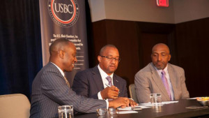 U. S. Black Chamber President/CEO Ron Busby signs Memorandum of Understanding with NAMAD President Damon Lester. Marc Bland, IHS vice president of diversity and inclusion, looks on.