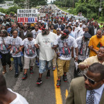 Michael Brown Sr. and his family leads a silent march in memory of his son Michael Brown Jr. on the one-year anniversary of his death. Photo/Lawrence Bryant/St. Louis American.