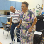 Carolyn Lewis-Carter receives physical therapy to improve her walking at Providence ElderPlace. She is being assisted by restorative aid Temesgen Haila. Photo/Cynthia Flash.