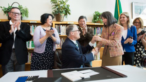 Governor Jay Inslee signs House Bill No. 1541 at Aki Kurose Middle School in Seattle. The bill, sponsored by Rep. Sharon Tomiko Santos, implements strategies to close the educational opportunity gap. Photo/Washington LSS.