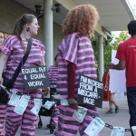 Protesters march in front of Sen. Steve O’Ban’s campaign launch in University Place to call attention to his voting practices regarding women’s equity issues .