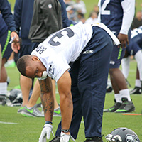 Seattle Seahawks running back Thomas Rawls stretches during warmups before his first practice this year at the VMAC Tuesday Morning. Rawls, who suffered a broken ankle last season, is expected to be ready for the season opener. Staff Photo/Khalid Bennett.