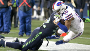 Buffalo Bills receiver Robert Woods is knocked out of bounds by Seahawk line back Brock Coyle during Seattle's 31-25 win over the Bills. Staff Photo/Khalid Bennett
